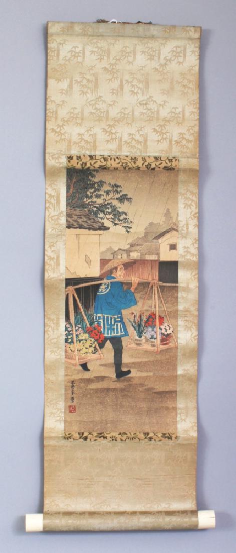 AN EARLY/MID 20TH CENTURY SIGNED JAPANESE HANGING: AN EARLY/MID 20TH CENTURY SIGNED JAPANESE HANGING SCROLL PRINT BY NISHIMURA HODO, with bone end pieces, originally sold by Takemura & Co., the print depicting a flower seller walking down a street, th