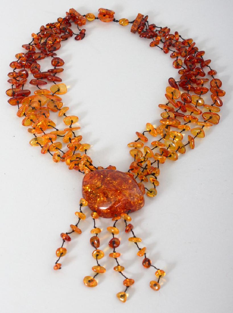 AN AMBER NECKLACE, weighing approx. 85gm, with four (1 of 3)
