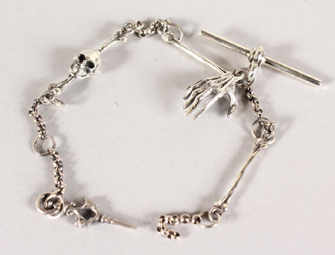 A SILVER SKULL AND BONE WATCH CHAIN.: A SILVER SKULL AND BONE WATCH CHAIN.