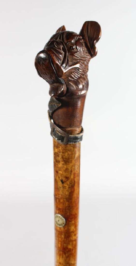 A WALKING STICK with carved wooden "DOG" handle by (1 of 2)
