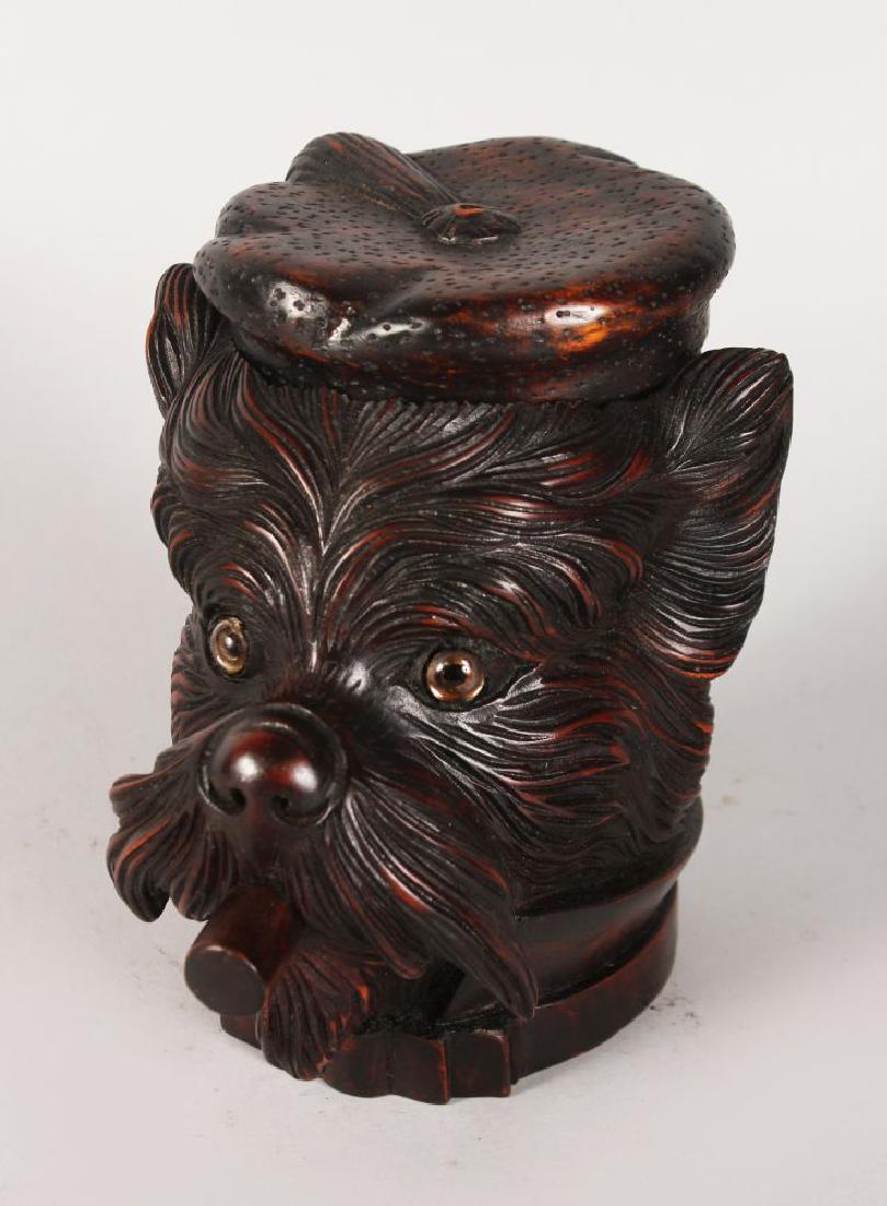 A BLACK FOREST DOG'S HEAD TOBACCO BOX, with lift off (1 of 2)