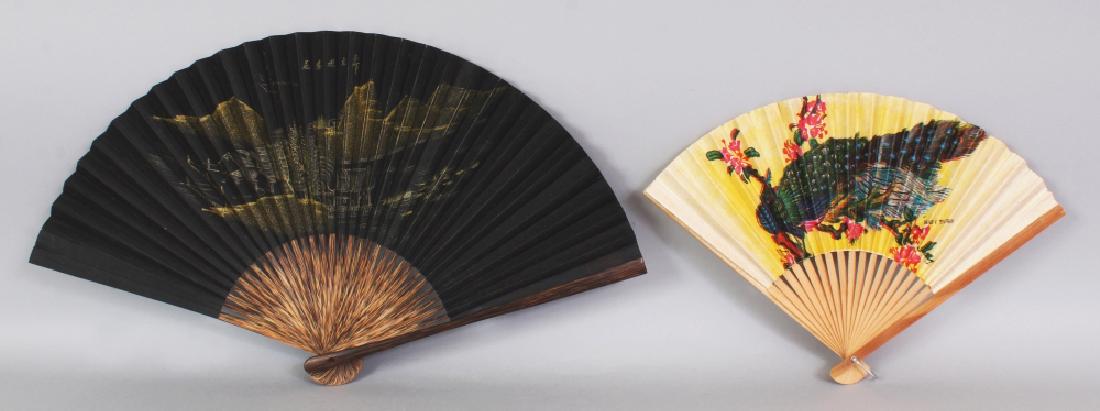 A 20TH CENTURY CHINESE BLACK GROUND GILT DECORATED: A 20TH CENTURY CHINESE BLACK GROUND GILT DECORATED PAPER FAN, with bamboo sticks, approx. 17in wide when opened & 10.5in long when closed; together with a smaller Taiwanese painted paper and bamboo fa