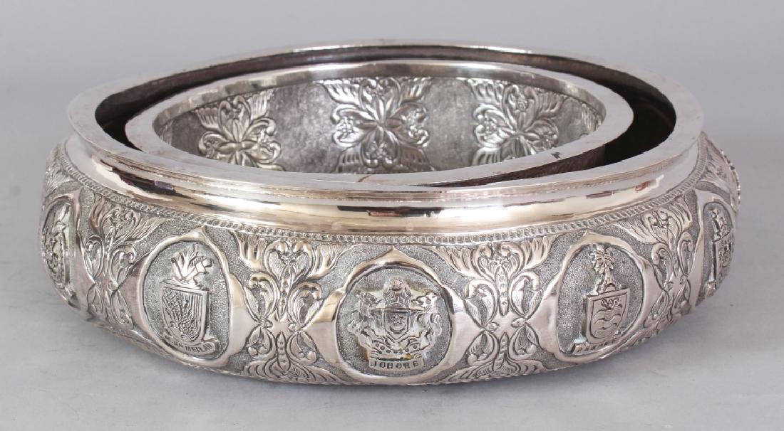 A GOOD EARLY 20TH CENTURY MALAYSIAN SILVER-METAL POSY: A GOOD EARLY 20TH CENTURY MALAYSIAN SILVER-METAL POSY RING BOWL, the sides embossed with the Federation Armorial and with the Armorials of the Eleven Malay Peninsular States, 8.75in diameter.