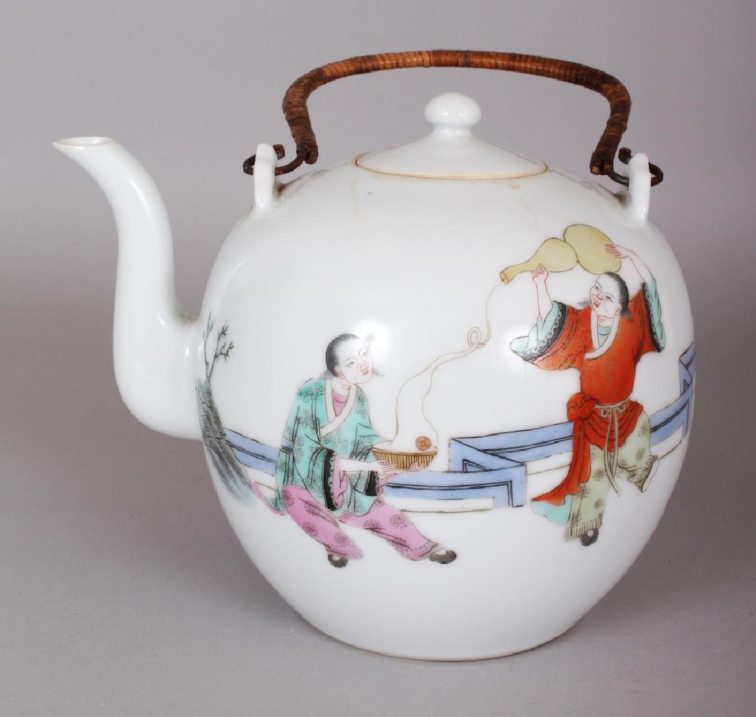 A LARGE EARLY 20TH CENTURY CHINESE FAMILLE ROSE: A LARGE EARLY 20TH CENTURY CHINESE FAMILLE ROSE GLOBULAR PORCELAIN TEAPOT & COVER, painted with playing youths and children in a fenced garden setting, 8.75in long including handle & 7.25in high to to