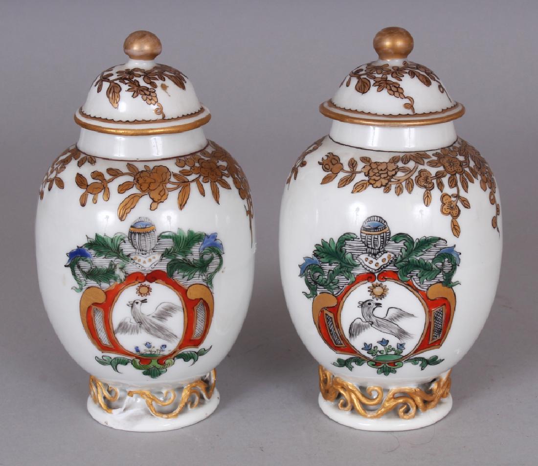 A PAIR OF SAMSON YONGZHENG STYLE FAMILLE ROSE ARMORIAL: A PAIR OF SAMSON YONGZHENG STYLE FAMILLE ROSE ARMORIAL PORCELAIN TEA CADDIES & COVERS, 5in high overall.