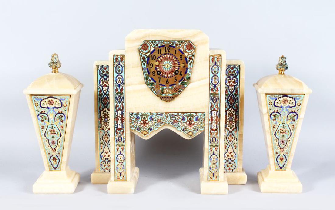 A SUPERB ART DECO CHAMPLEVE ENAMEL AND MARBLE THREE: A SUPERB ART DECO CHAMPLEVE ENAMEL AND MARBLE THREE PIECE CLOCK SET CIRCA 1920, the case of Turkish design with Champleve panels with an eight day movement. 14in high complete with a pair of side piec