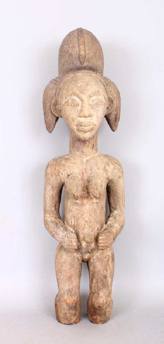 AN EARLY CARVED WOOD TRIBAL FIGURE with lime pigment. (1 of 2)