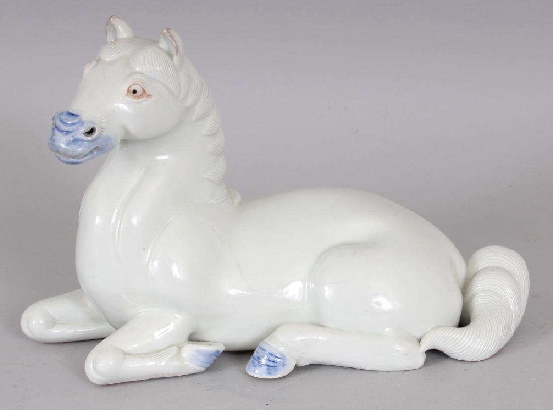 A GOOD JAPANESE HIRADO PORCELAIN MODEL OF A HORSE,: A GOOD JAPANESE HIRADO PORCELAIN MODEL OF A HORSE, circa 1900, glazed predominantly white with the hooves and mouth in underglaze-blue, the unglazed base with an impressed maker’s mark, 8.75in long 