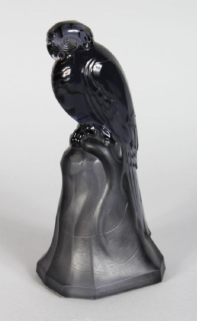 A VAL ST LAMBERT COLOURED GLASS PARROT standing on a: A VAL ST LAMBERT COLOURED GLASS PARROT standing on a tree stump. Signed VAL ST LAMBERT, BELGIQUE. 7.5ins high.