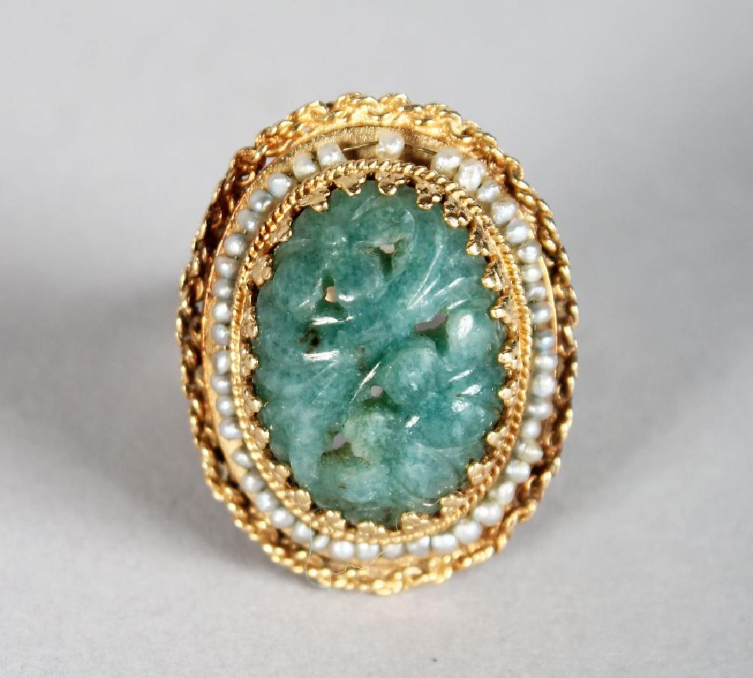 A GOLD AND JADE RING, the oval jade stone with carved (1 of 1)