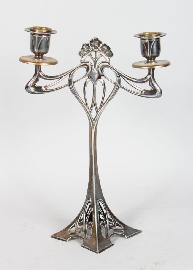 A WMF SILVER PLATED ART NOUVEAU TWIN BRANCH CANDELABRA.: A WMF SILVER PLATED ART NOUVEAU TWIN BRANCH CANDELABRA. 12ins high.