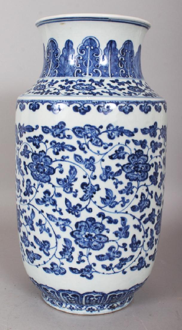 A GOOD QUALITY MING STYLE BLUE & WHITE PORCELAIN VASE,: A GOOD QUALITY MING STYLE BLUE & WHITE PORCELAIN VASE, painted in an 18th Century manner with a heaped and piled scrolling foliate design, 14.3in high.