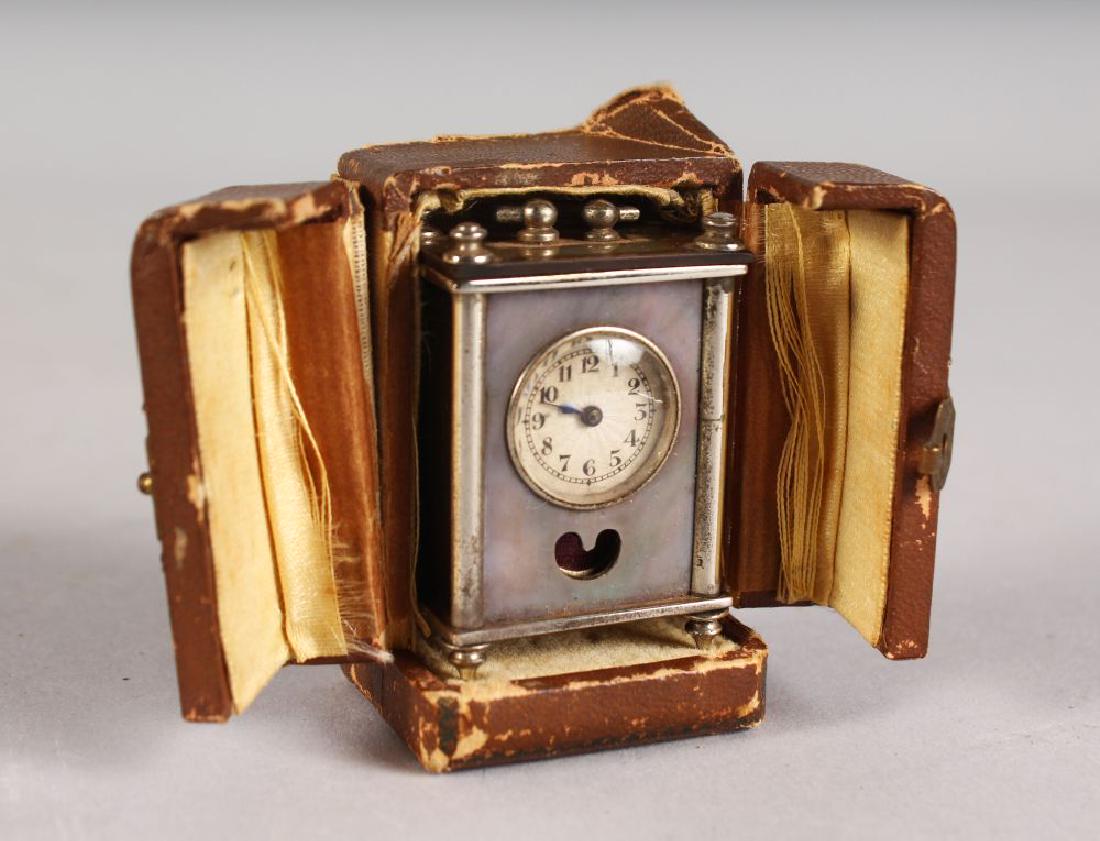 A MINIATURE BREVET NICKEL CLOCK, 2ins high, in a (1 of 2)