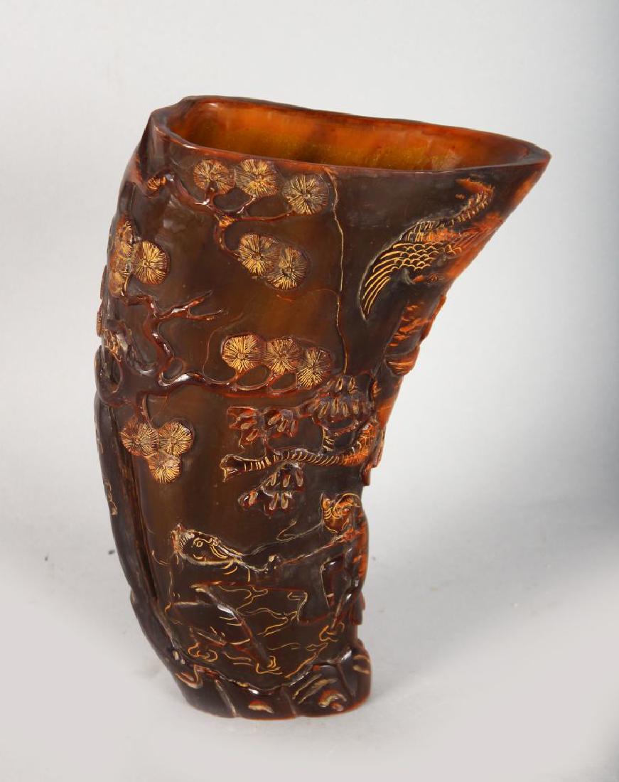 A TALL CHINESE CARVED HORN LIBATION CUP, depicting (1 of 3)
