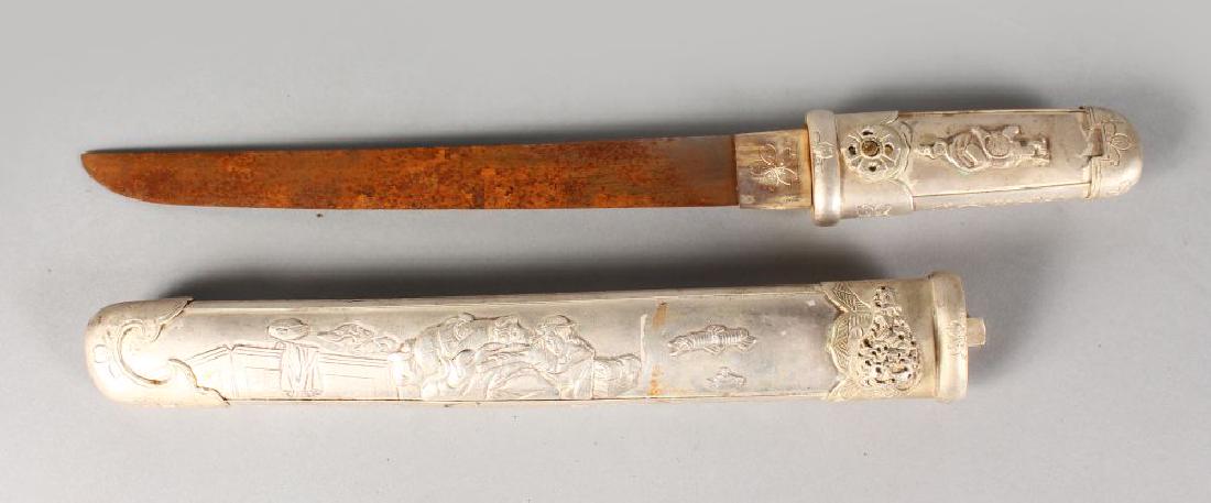 A JAPANESE WHITE METAL DAGGER, depicting erotic scenes: A JAPANESE WHITE METAL DAGGER, depicting erotic scenes to the scabbard. 1ft 5ins long.