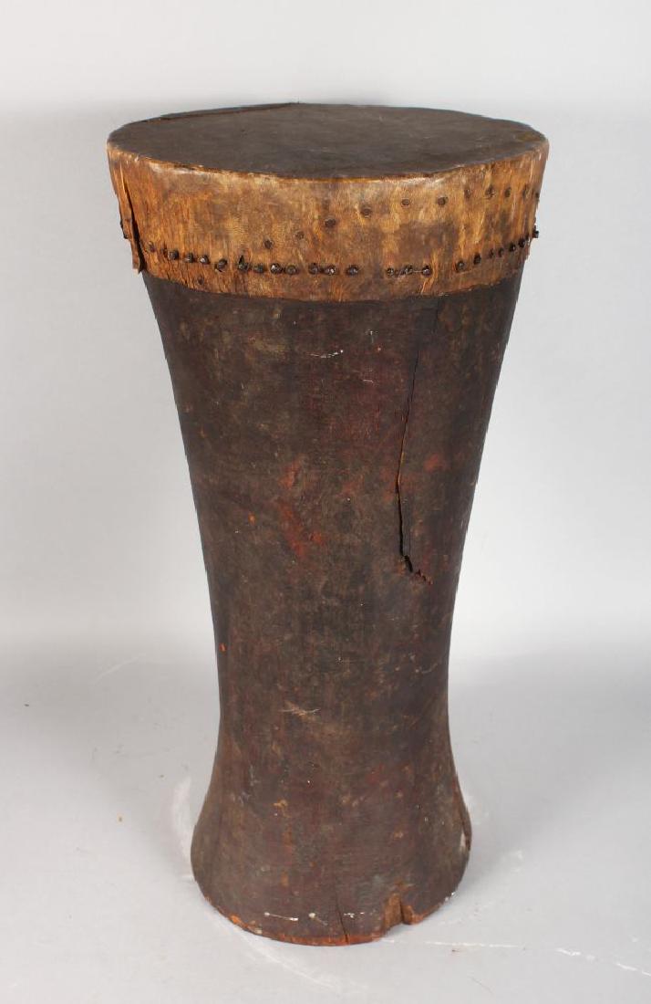 AN AFRICAN DRUM. 22ins high.: AN AFRICAN DRUM. 22ins high.