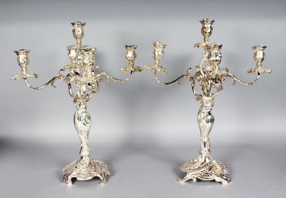A GOOD PAIR OF SILVER PLATED FOUR BRANCH CANDELABRA: A GOOD PAIR OF SILVER PLATED FOUR BRANCH CANDELABRA with acanthus scrolling branches. 19ins high.