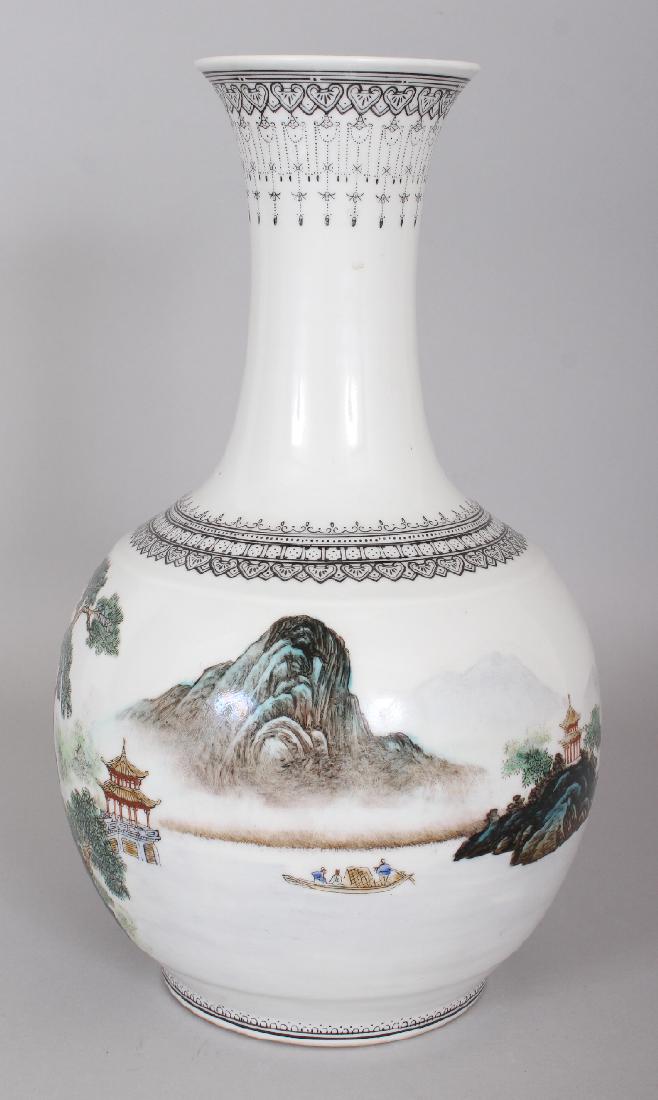 A 20TH CENTURY CHINESE FAMILLE ROSE PORCELAIN BOTTLE: A 20TH CENTURY CHINESE FAMILLE ROSE PORCELAIN BOTTLE VASE, the sides painted with a continuous river landscape scene, the base with a Qianlong seal mark, 11.25in high.