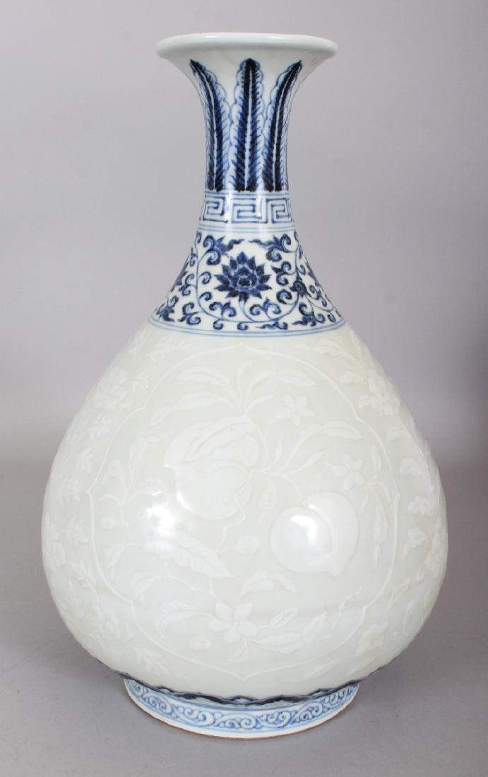 A CHINESE MING STYLE UNDERGLAZE-BLUE & WHITE SLIP: A CHINESE MING STYLE UNDERGLAZE-BLUE & WHITE SLIP DECORATED YUHUCHUNPING PORCELAIN VASE, the base with a six-character Xuande mark, 12.8in high.