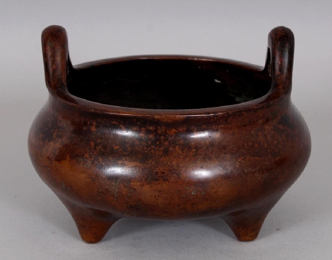A CHINESE BRONZE TRIPOD CENSER, weighing approx. 865gm,: A CHINESE BRONZE TRIPOD CENSER, weighing approx. 865gm, the base cast with an unusually rendered Xuande mark, 5.1in wide at widest point & 4.3in diameter at rim & 2.7in high to rim & 3.7in high to top