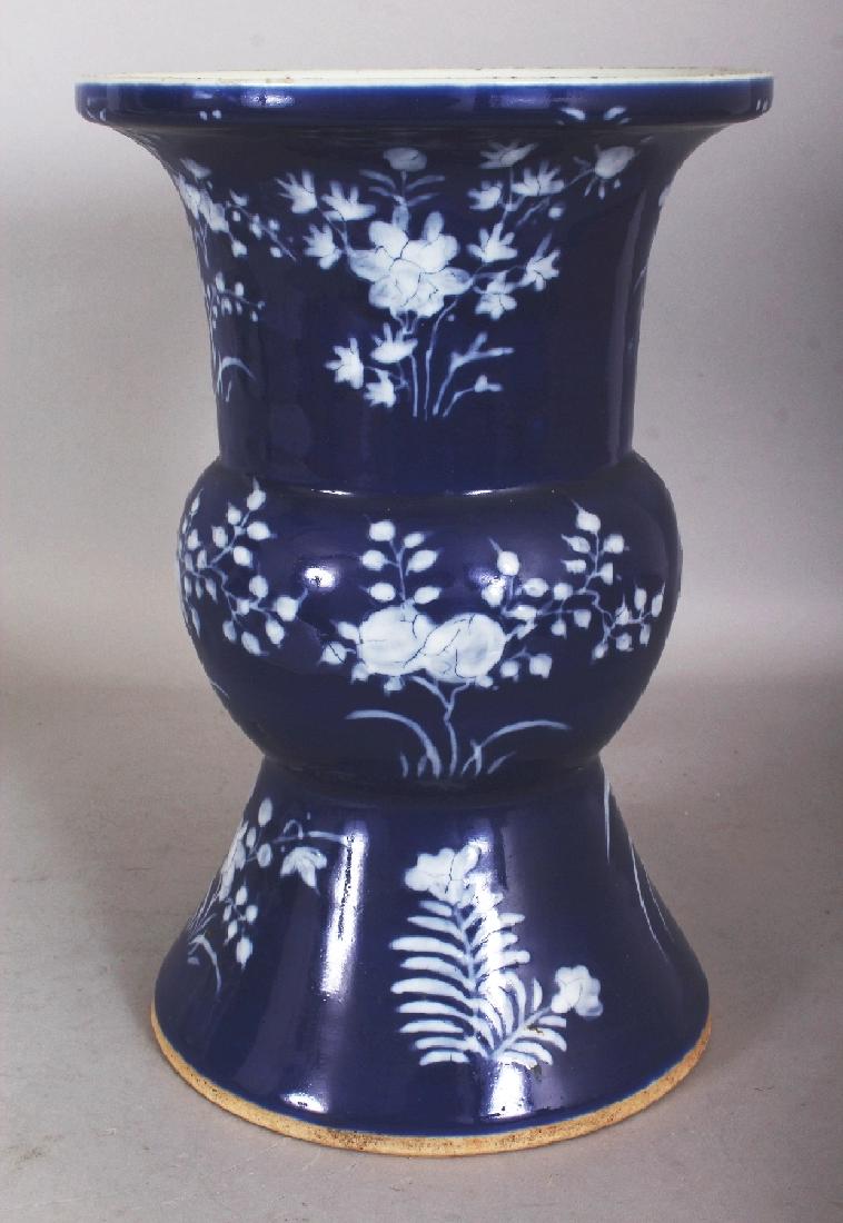A 19TH CENTURY CHINESE BLUE GROUND WHITE SLIP DECORATED: A 19TH CENTURY CHINESE BLUE GROUND WHITE SLIP DECORATED PORCELAIN VASE, decorated with sprays of fruit and of foliage, 8.7in diameter at rim & 13in high.