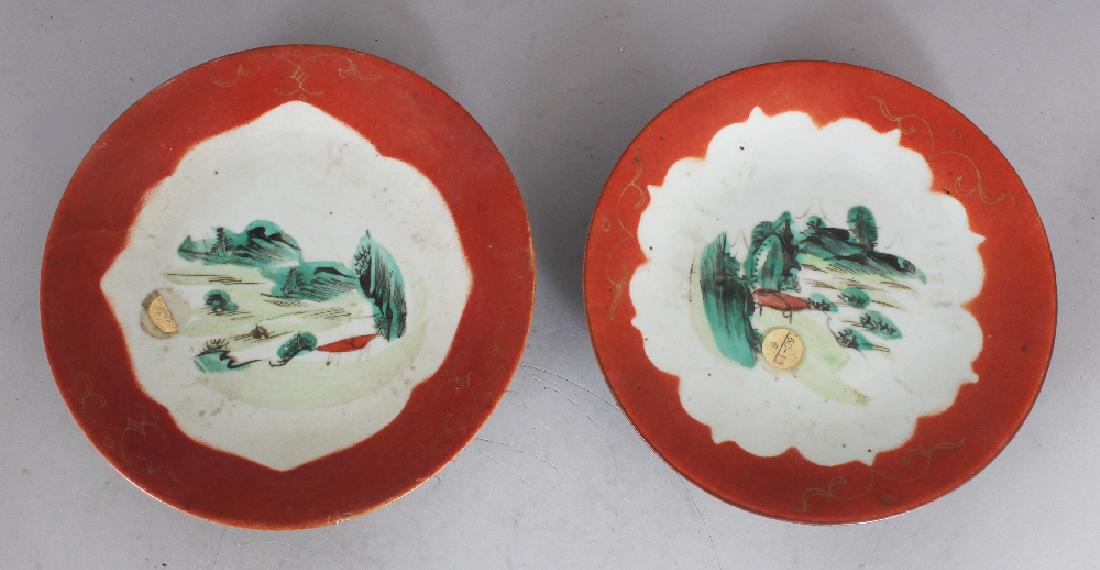 TWO 19TH CENTURY CHINESE FAMILLE ROSE PROVINCIAL: TWO 19TH CENTURY CHINESE FAMILLE ROSE PROVINCIAL PORCELAIN DISHES, each painted with a shaped landscape panel reserved on a coral ground, each base with a stylised seal mark, 7.7in & 7.4in diameter (2