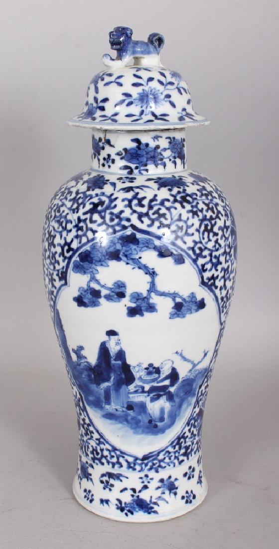 A 19TH CENTURY CHINESE BLUE & WHITE PORCELAIN VASE &: A 19TH CENTURY CHINESE BLUE & WHITE PORCELAIN VASE & COVER, painted with quatrefoil panels of a sage and boy attendant, the base with a four-character Kangxi mark, 12.6in high overall.