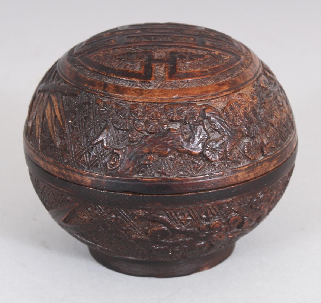 A GOOD QUALITY 19TH CENTURY CHINESE CARVED WOOD: A GOOD QUALITY 19TH CENTURY CHINESE CARVED WOOD SPHERICAL BOX & COVER, the domed cover carved with a Shou medallion, 3.5in diameter & 3in high overall.