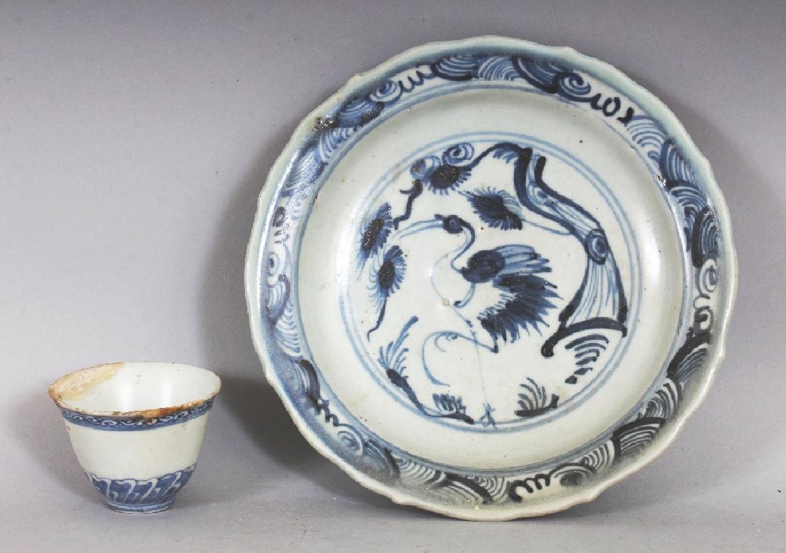 A CHINESE MING DYNASTY BLUE & WHITE PROVINCIAL: A CHINESE MING DYNASTY BLUE & WHITE PROVINCIAL PORCELAIN DISH, with a barbed rim, painted with a stork beneath a pine tree, 7.7in diameter; together with a 17th Century blue and white shipwreck wine c