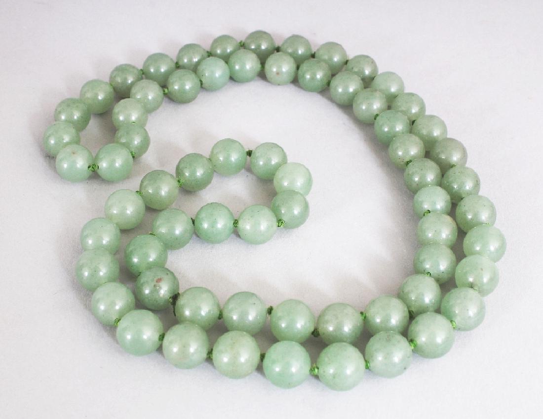 A JADE-LIKE GREEN HARDSTONE NECKLACE, composed of (1 of 2)