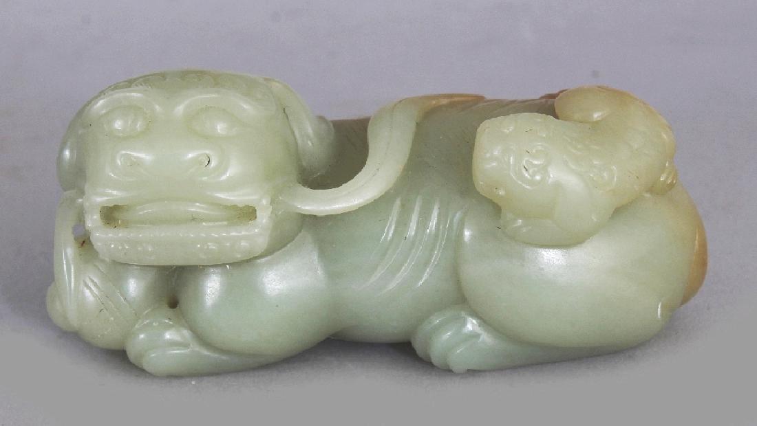 A CHINESE CELADON JADE MODEL OF A BUDDHISTIC LION & ITS (1 of 6)