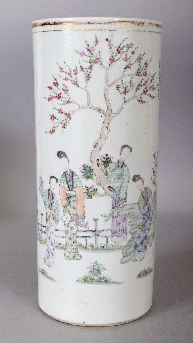 A CHINESE REPUBLIC PERIOD FAMILLE ROSE CYLINDRICAL: A CHINESE REPUBLIC PERIOD FAMILLE ROSE CYLINDRICAL PORCELAIN VASE, painted with calligraphy and with a group of ladies in a fenced garden setting, 4.6in diameter at base & 11in high.