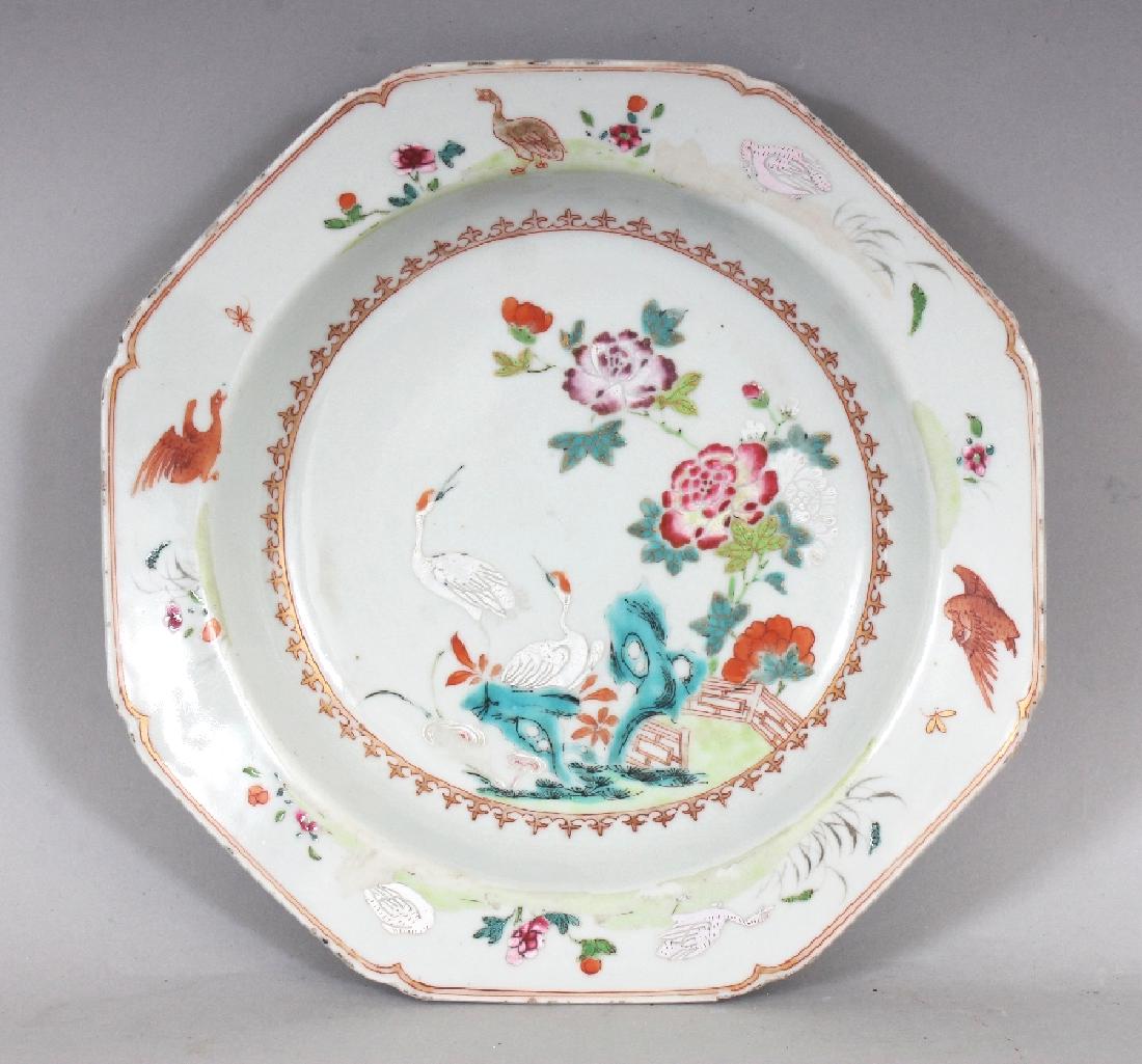 ANOTHER 18TH CENTURY CHINESE QIANLONG PERIOD FAMILLE: ANOTHER 18TH CENTURY CHINESE QIANLONG PERIOD FAMILLE ROSE PORCELAIN SOUP PLATE, of octagonal form with indented corners, painted to its interior with storks in a garden scene, 8.7in wide.