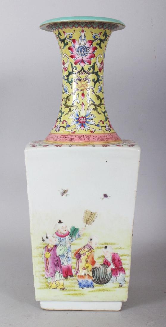 A GOOD QUALITY CHINESE FAMILLE ROSE PORCELAIN BOYS: A GOOD QUALITY CHINESE FAMILLE ROSE PORCELAIN BOYS VASE, the flaring sides painted with groups of playing boys, the yellow ground waisted neck with formal lotus, bats and wan, the base with a Qianlong