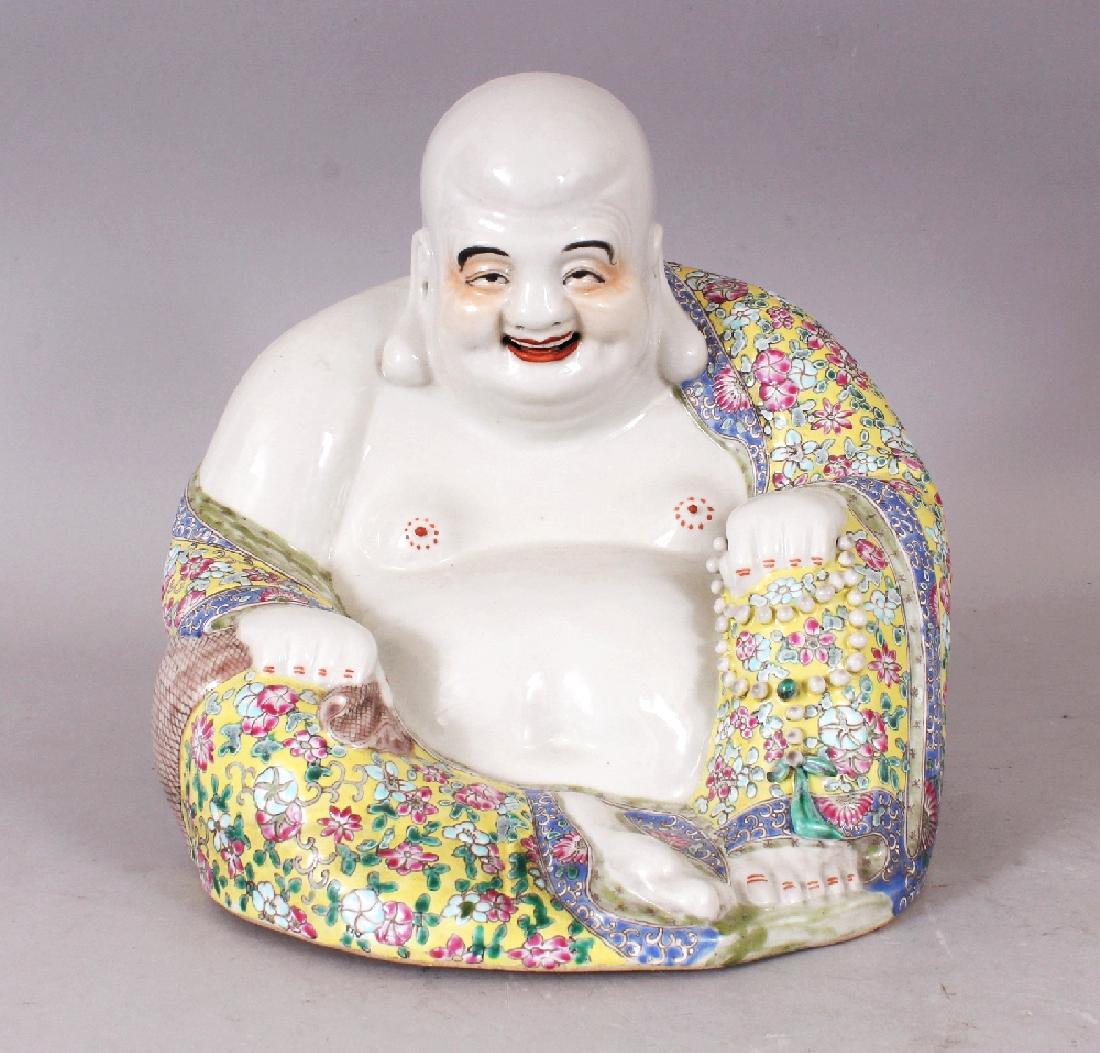 A CHINESE FAMILLE ROSE YELLOW GROUND PORCELAIN FIGURE: A CHINESE FAMILLE ROSE YELLOW GROUND PORCELAIN FIGURE OF BUDAI, seated with exposed belly and cheerful expression, the unglazed base with an indistinct impressed seal mark, 9.8in wide at widest point 