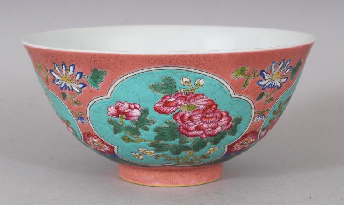 A CHINESE FAMILLE ROSE PINK GROUND PORCELAIN BOWL, the: A CHINESE FAMILLE ROSE PINK GROUND PORCELAIN BOWL, the sides decorated with turquoise ground ruyi form panels of flowers and leafage, the base with a four-character mark, 5.8in diameter & 2.75in high.