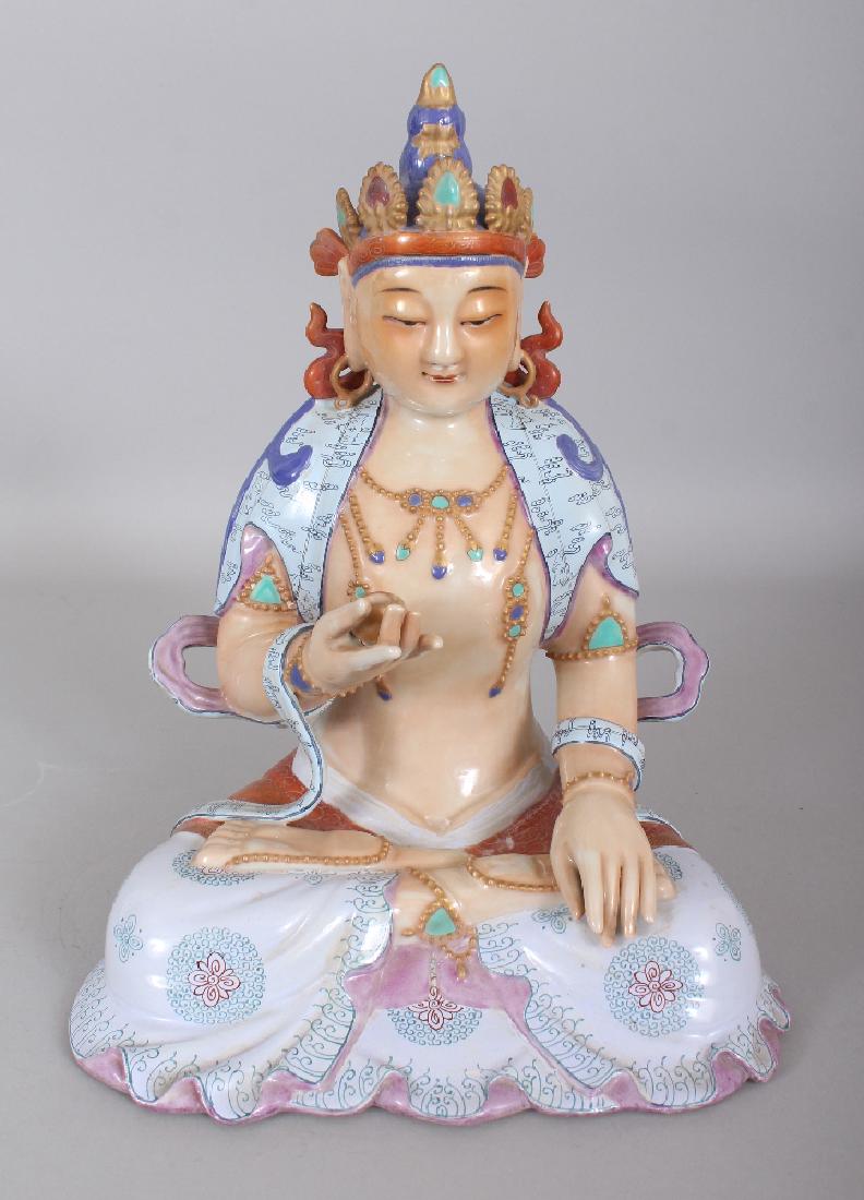 A CHINESE FAMILLE ROSE PORCELAIN FIGURE OF BUDDHA,: A CHINESE FAMILLE ROSE PORCELAIN FIGURE OF BUDDHA, seated in dhyanasana and bearing a cup in one hand, the base unglazed, 11.25in high.