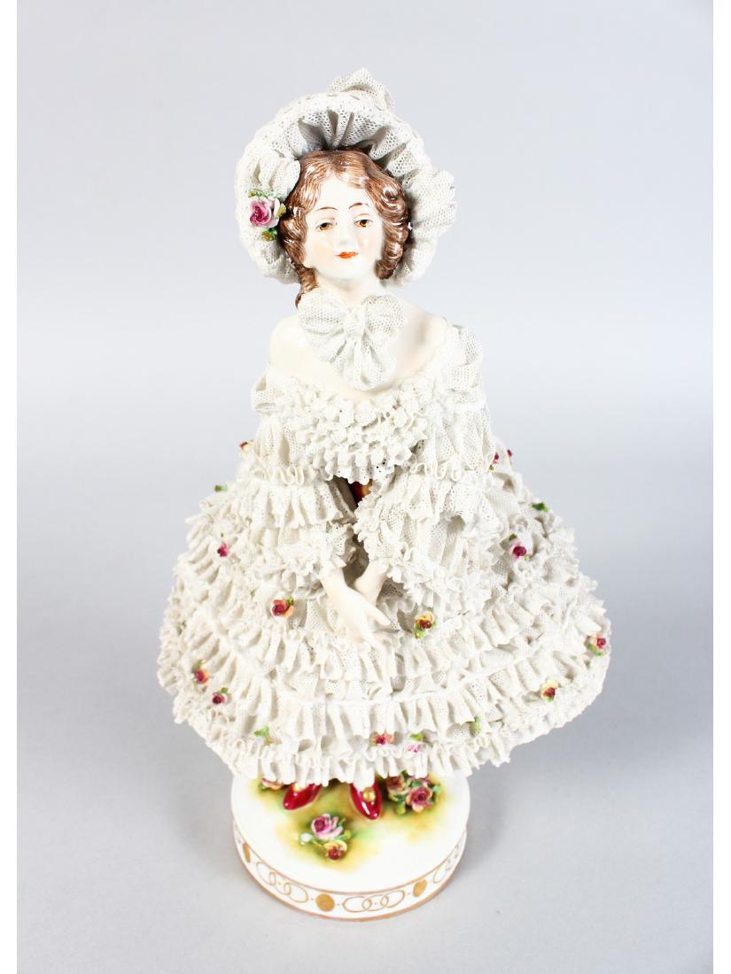 A FRENCH PORCELAIN FIGURE OF A YOUNG GIRL in a lace: A FRENCH PORCELAIN FIGURE OF A YOUNG GIRL in a lace dress. 12ins high.