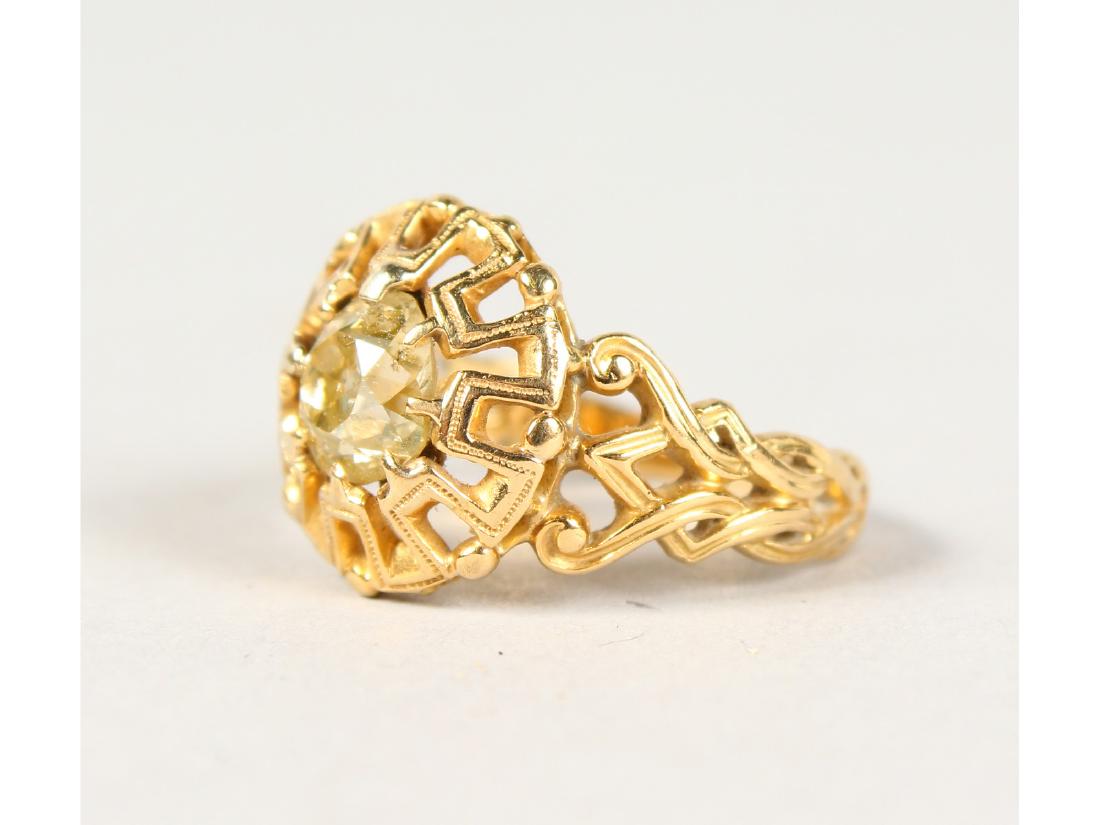 A PIERCED YELLOW GOLD AND DIAMOND SET RING. (1 of 2)