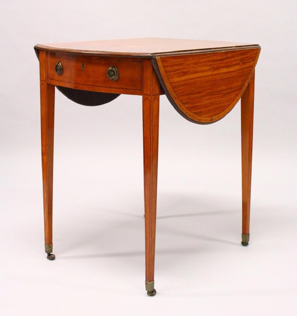 A GOOD GEORGE III SATINWOOD OVAL PEMBROKE TABLE, the: A GOOD GEORGE III SATINWOOD OVAL PEMBROKE TABLE, the boxwood crossbanding having pen work decoration, a drawer to one end, on tapering square legs with brass castors. 2ft 3ins long x 1ft 8ins wide x 2