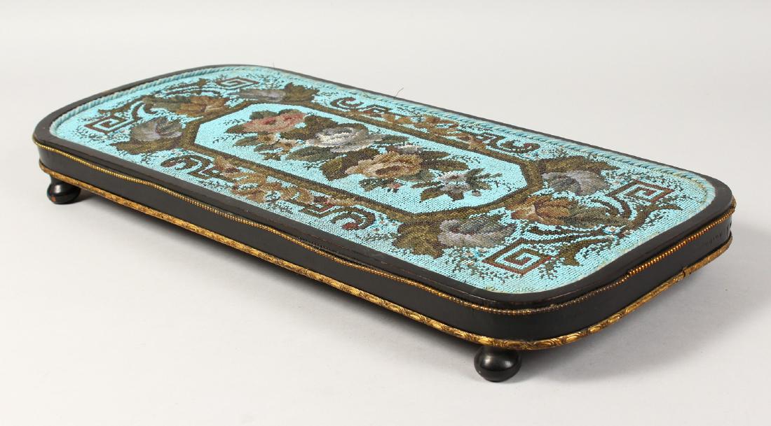 A VICTORIAN LONG STAND, the bead work top with roses,: A VICTORIAN LONG STAND, the bead work top with roses, supported on four ball feet. 22ins long.