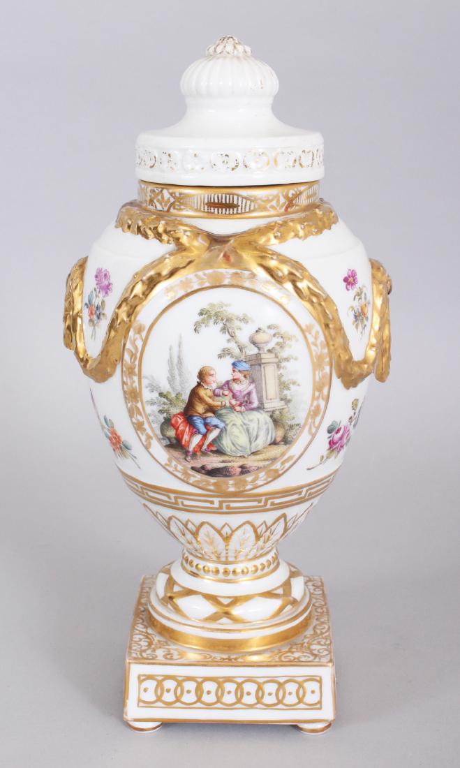 A BERLIN PORCELAIN URN SHAPED VASE AND COVER, with: A BERLIN PORCELAIN URN SHAPED VASE AND COVER, with reverse panels of young lovers, with gilt swags. Mark in blue. 10ins high.