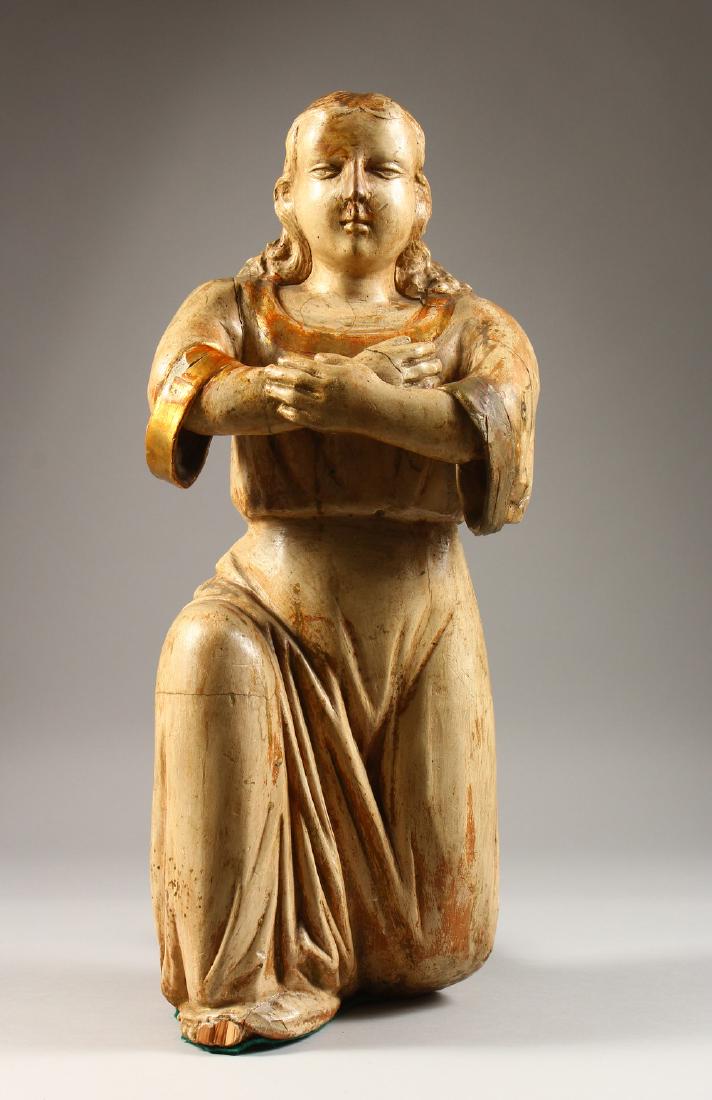 AN 18TH CENTURY ITALIAN CARVED WOOD AND PAINTED: AN 18TH CENTURY ITALIAN CARVED WOOD AND PAINTED KNEELING FIGURE, with arms crossed. 1ft 8ins high.