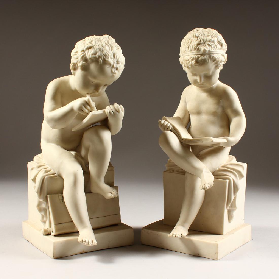 A PAIR OF PARIAN FIGURES OF CUPIDS sitting on a plinth.: A PAIR OF PARIAN FIGURES OF CUPIDS sitting on a plinth. 12ins high.