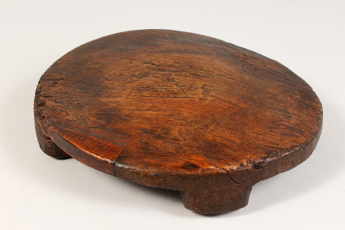 AN EARLY ETHNIC CIRCULAR WOODEN LOW STOOL OR TABLE with (1 of 5)