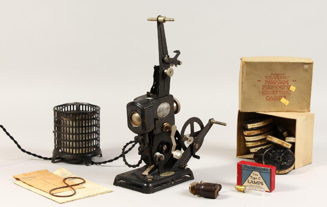 A PATHESCOPE FILM PROJECTOR, "Supplied by the: A PATHESCOPE FILM PROJECTOR, "Supplied by the Photographic Repair and Supply Depot H. G. Thompson, 5 Northampton Street, Leicester", with several reels of film.