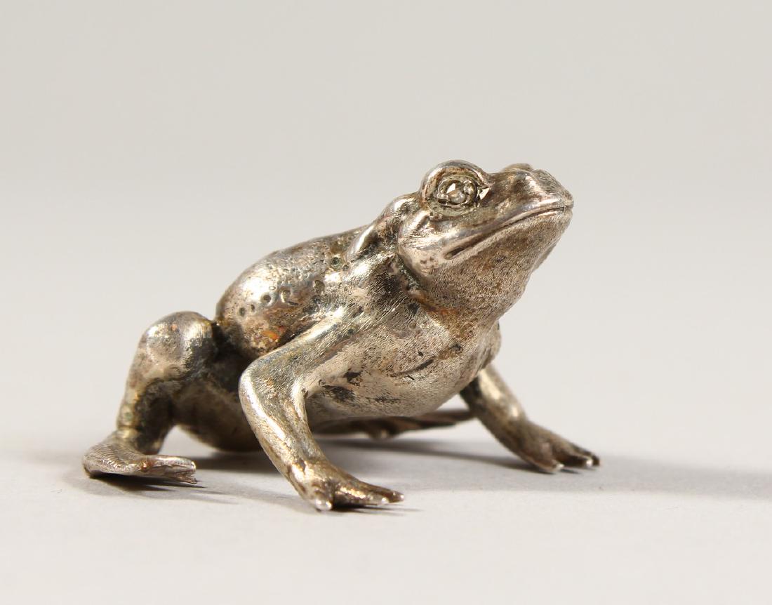A CAST SILVER MODEL OF A FROG, with diamond eyes. (1 of 6)
