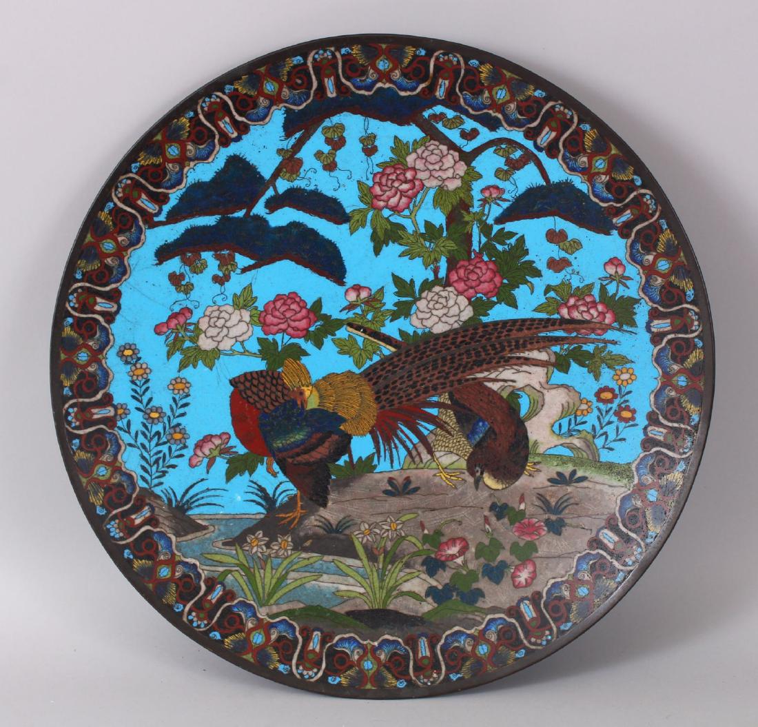 A LARGE JAPANESE CLOISONNE ENAMEL CIRCULAR CHARGER,: A LARGE JAPANESE CLOISONNE ENAMEL CIRCULAR CHARGER, the front decorated with brilliant coloured birds and flowers, 48cm diameter. Note: A little Cloisonne enamel missing from the reverse side.