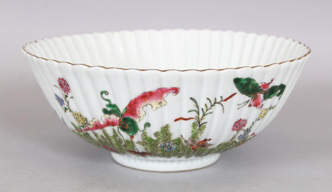 A CHINESE FAMILLE ROSE FLUTED PORCELAIN BOWL, the sides: A CHINESE FAMILLE ROSE FLUTED PORCELAIN BOWL, the sides decorated with butterflies and foliage, the interior with fish swimming amidst water weeds, the base with a hallmark, 8.3in diameter & 3.3in hig
