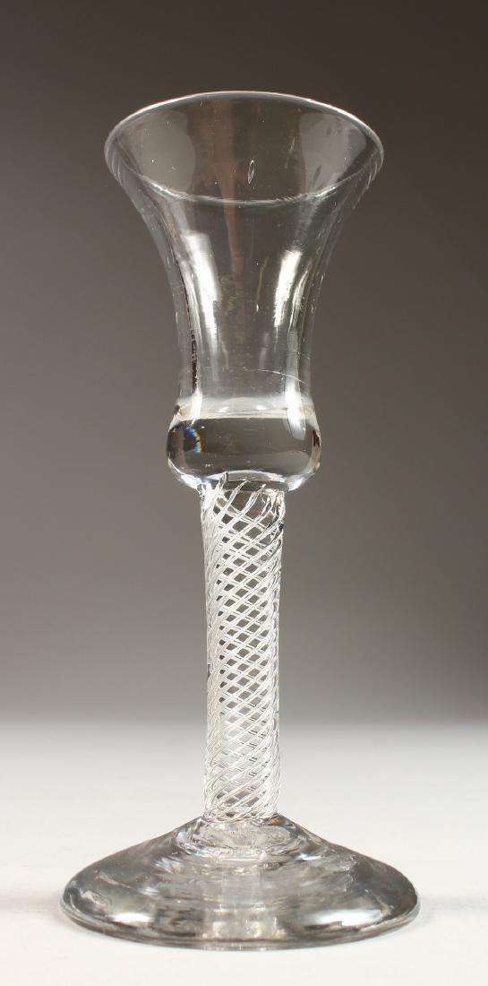 A GEORGIAN WINE GLASS, with air twist stem, inverted: A GEORGIAN WINE GLASS, with air twist stem, inverted bell bowl and firing foot. 6ins high.